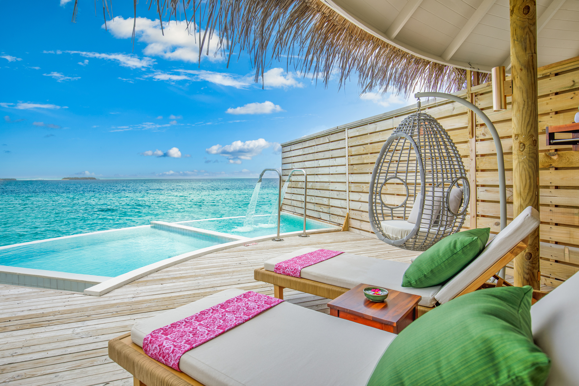 A spacious, romantic Fijian bure with a four-poster bed near the sea